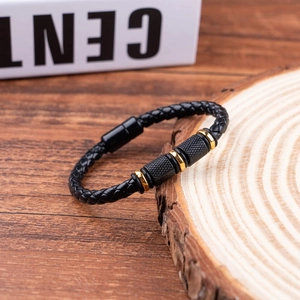 Men's black braided leather bracelet with gold metal accents and magnetic clasp
