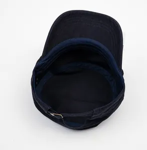 Detail of dark blue military flat top cap showing sweatband and metal adjustable buckle