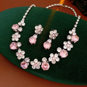 Detailed macro view of the pink zircon flower necklace and matching stud earrings set