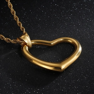 Elegant gold heart pendant necklace with twist chain on a premium black background