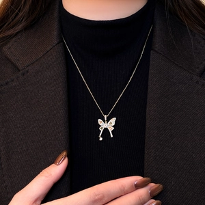Detail of elegant butterfly necklace with multicolor micro-pave zircon crystals on gold chain