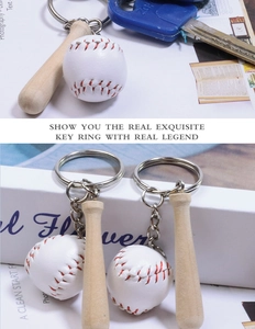 Detailed view of mini wooden baseball bat and white leather ball keychain with metal ring