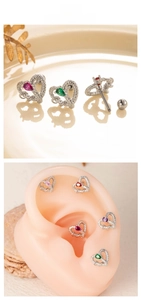 Detailed view of heart-shaped titanium steel cartilage studs with colorful zircons