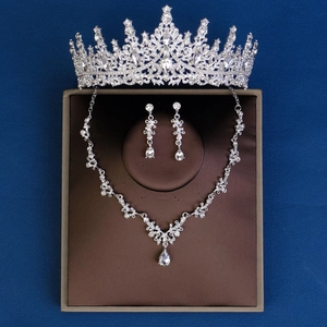 Luxury bridal jewelry set featuring a silver tiara, necklace, and earrings with crystals