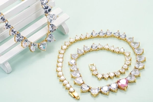 Hip hop style heart tennis necklace with white and pink cubic zirconia in gold plating