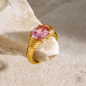 Close-up of a vintage 18k gold plated ring featuring a large oval pink gemstone