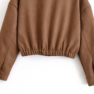 Detailed back view of brown suede jacket featuring an elastic hem and textured fabric