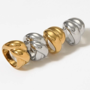 Set of four gold and silver croissant dome rings in twisted stainless steel design