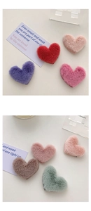 Close-up of soft plush heart-shaped hair clips in various colorful macaron pastel shades
