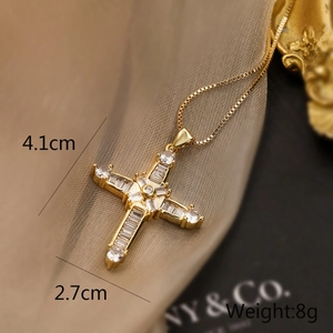 Detailed view of 18K gold plated cross pendant necklace featuring shimmering zircons