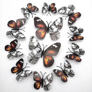 Lot de 12 stickers muraux papillon crâne 3D disposés en cercle sur fond blanc