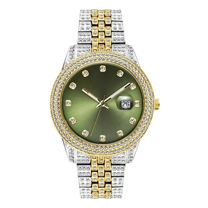 Detail of a luxury iced-out watch featuring a green dial and diamond-set bicolor strap