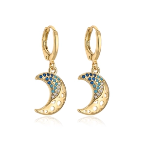 Detail of 18K gold crescent moon earrings featuring blue and white zircon stones