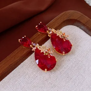 Luxury drop earrings featuring a pear-shaped red ruby stone and colorful zircon flowers