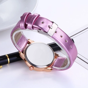Detail view of the rose gold watch case back and pink textured leather strap with buckle