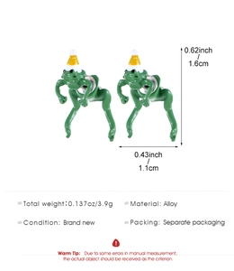Detailed view of creative green frog earrings with party hats showing size and weight specs