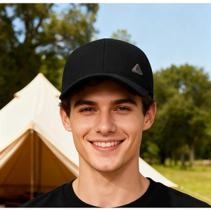 Close-up of black winter baseball cap with a stylish triangular metal logo on the side