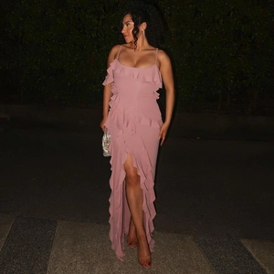 Detail of pink backless slit dress showing ruffled layers and high leg opening design