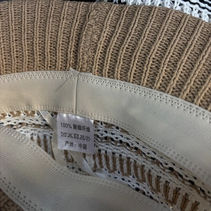 Close-up of the breathable knitted sun hat interior showing sweatband and washing label
