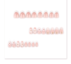 Detail of 3D embossed flowers and seashell texture on pink almond press-on nails