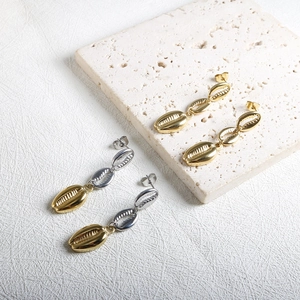 Exaggerated stainless steel conch shell earrings in gold and two-tone finishes