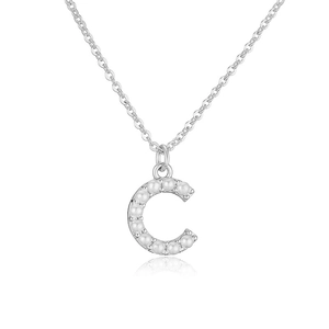 Detail of silver letter C necklace pendant inlaid with elegant white pearls on white background