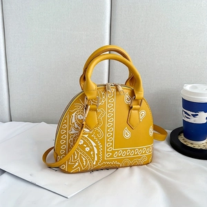 Yellow shell handbag with white bandana pattern and elegant golden metal handles