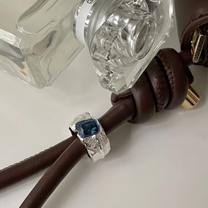 Detailed view of an irregular S925 silver ring with a rectangular royal blue gemstone