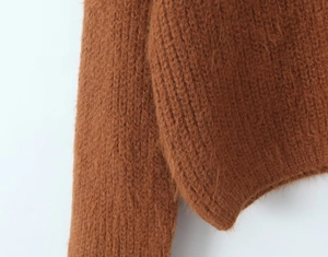 Detailed close-up of brown mohair cardigan sleeves showing soft ribbed knit texture