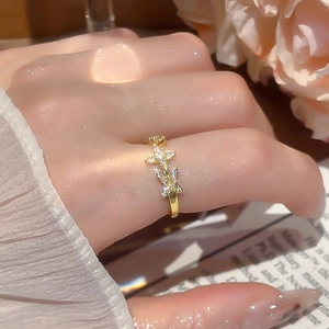 Detailed view of 18k gold plated flower star ring with sparkling zircons on a finger