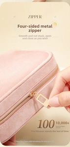 Close-up of durable golden zipper on premium pink velvet travel jewelry case