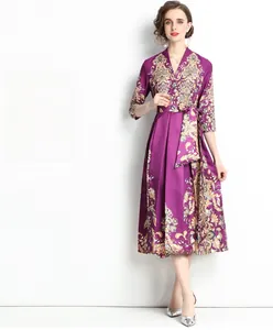 Detail of purple vintage floral print dress with court style patterns and satin texture