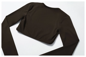 Close-up of brown long sleeve crop top yoga set with smooth elastic fabric texture