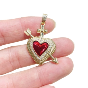 Golden arrow through heart pendant with red inlay and micro-set cubic zirconia stones