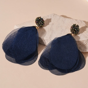 Detail of dark blue layered fabric petals and colorful beads on bohemian floral earrings