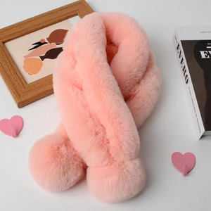 Detail of soft pink faux rabbit fur scarf featuring large decorative fluffy pom poms