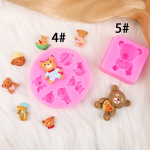 Pink silicone bear molds with teddy bears in various outfits on white plush background