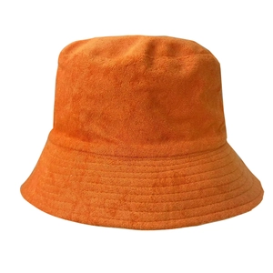 Detailed close-up of orange bucket hat featuring premium terry cloth fabric texture