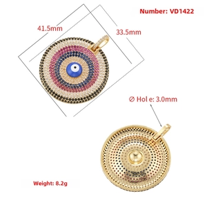 Detailed close-up of gold evil eye heart pendant with colorful pavé rhinestones