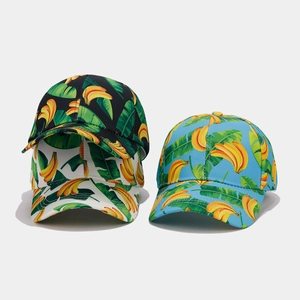 Detailed close-up of tropical banana print patterns in black, white, and blue hat variants