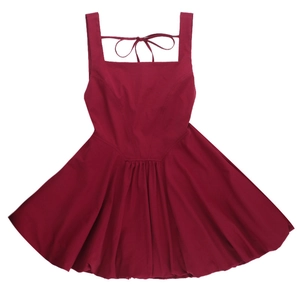 Detail of red square neck sleeveless dress featuring a back tie-up bow design