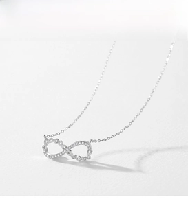 Macro view of sterling silver infinity necklace with sparkling zircon pavé setting