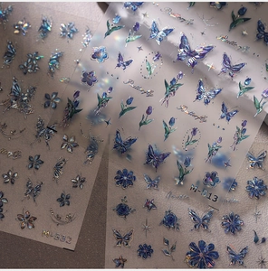 Macro detail of laser holographic butterfly and flower nail stickers in M-513 and M-532