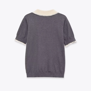 Detail of the back of a grey knit top with a white Peter Pan collar and scalloped lace trim