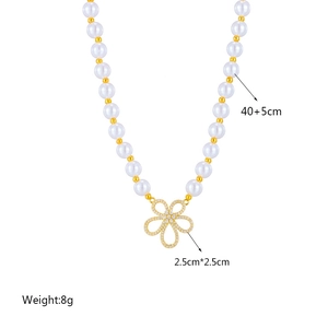 Elegant pearl necklace with a 2.5cm gold hollow flower pendant and zirconia inlay
