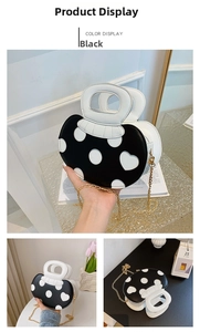 Detail view of mushroom-shaped crossbody bag with polka dots and golden chain strap