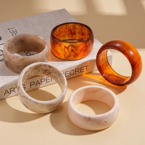 Vintage resin bangle set with marble and tortoiseshell patterns on artistic props