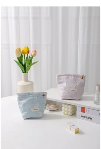 Detailed view of floral canvas swan cosmetic bags with metal flower zipper charms