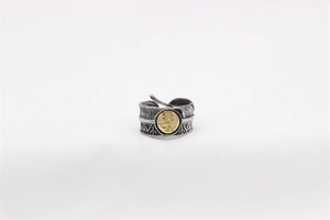 Detail of vintage feather ring showing intricate silver texture and gold eagle totem inlay