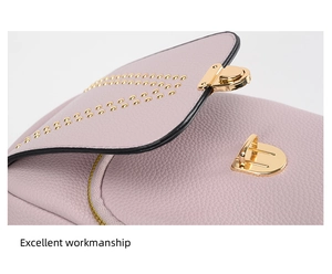 Detail of pink leather bag featuring gold studs, rotating lock and excellent workmanship